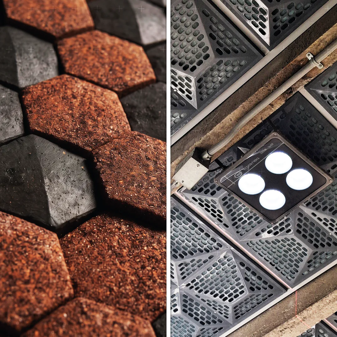 Revestimiento de hexágonos de material reciclado y cielo acústico perforado con luminaria